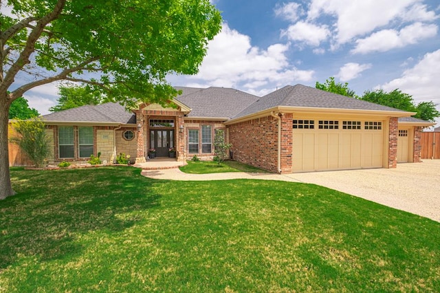 1900 Fringewood Dr, Midland, TX 79707 - ranch-style home with brick siding, a shingled roof, a garage, driveway, and a front lawn