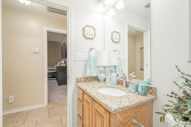 1900 Fringewood Dr, Midland, TX 79707 - bathroom featuring tile patterned floors, visible vents, vanity, and baseboards