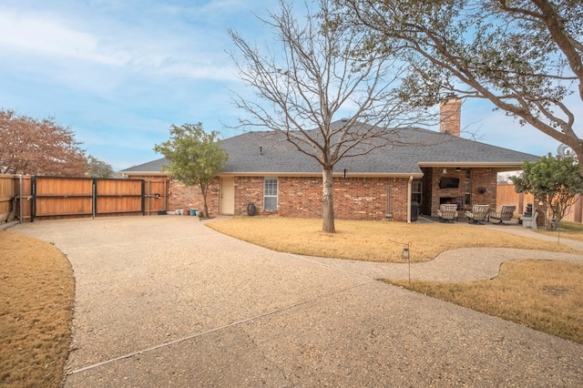 1900 Fringewood Dr, Midland, TX 79707 - back of house with brick siding, a chimney, a gate, roof with shingles, and fence