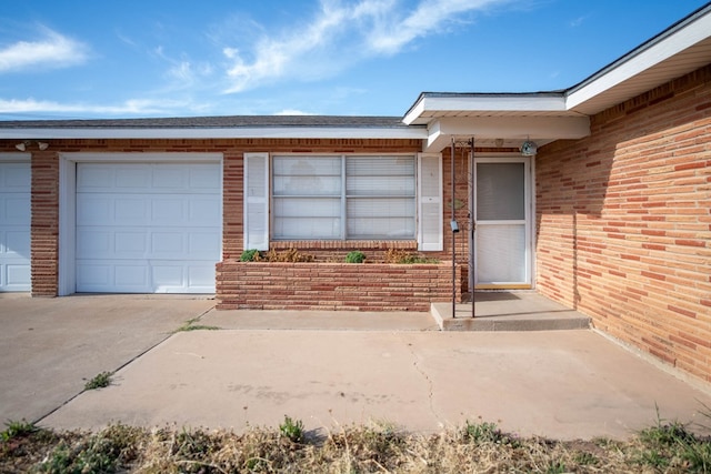 doorway to property with brick siding