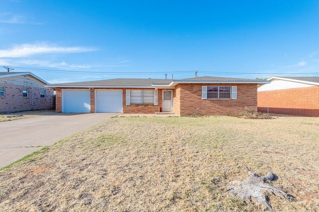 ranch-style home featuring concrete driveway, an attached garage, brick siding, and a front lawn