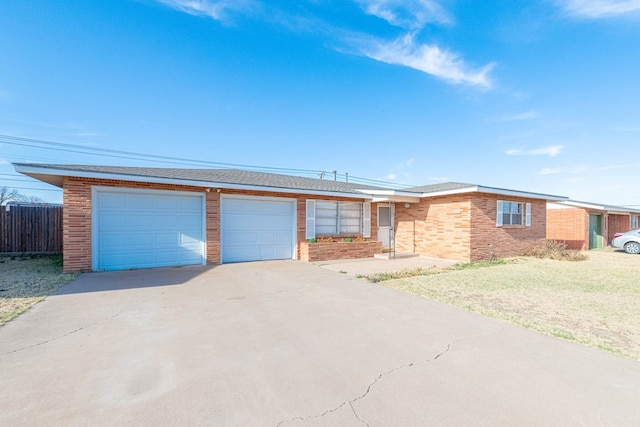 ranch-style home with brick siding, an attached garage, a front lawn, fence, and driveway