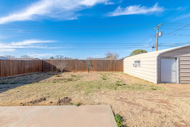 view of yard featuring an outdoor structure and a fenced backyard