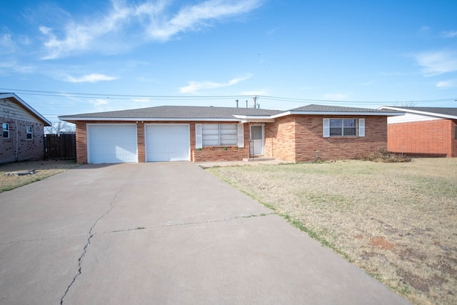 ranch-style home with a front yard, fence, driveway, a garage, and brick siding