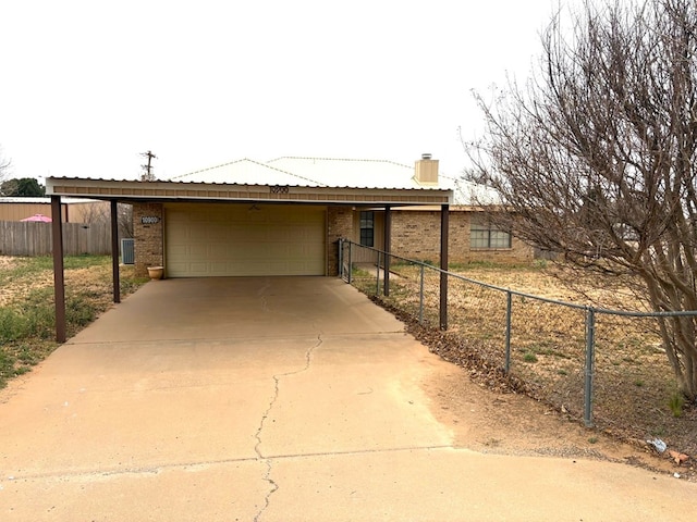 view of front of property with brick siding, fence, a chimney, a carport, and driveway