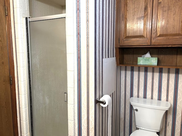 full bathroom featuring toilet and a stall shower