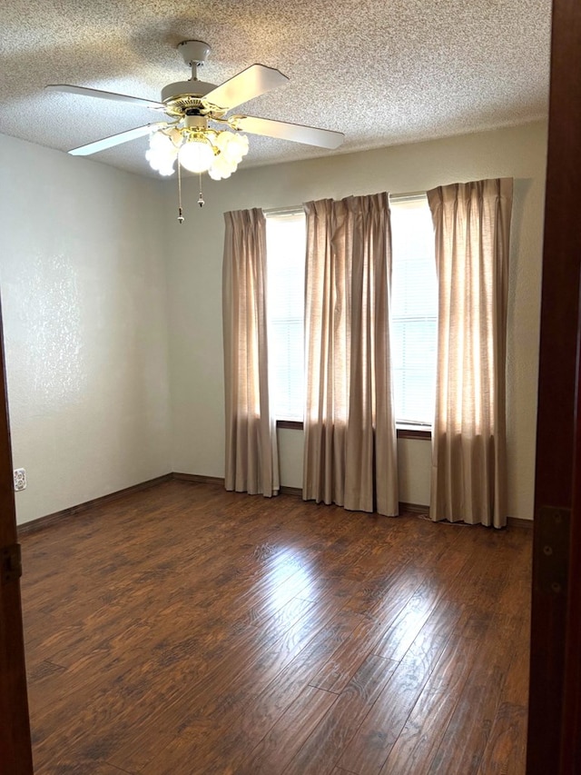 empty room with a textured ceiling, ceiling fan, and hardwood / wood-style flooring