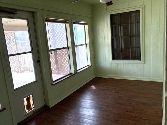 unfurnished sunroom with plenty of natural light and ceiling fan