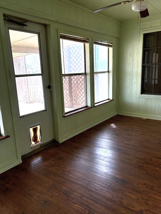 spare room featuring dark wood finished floors and ceiling fan