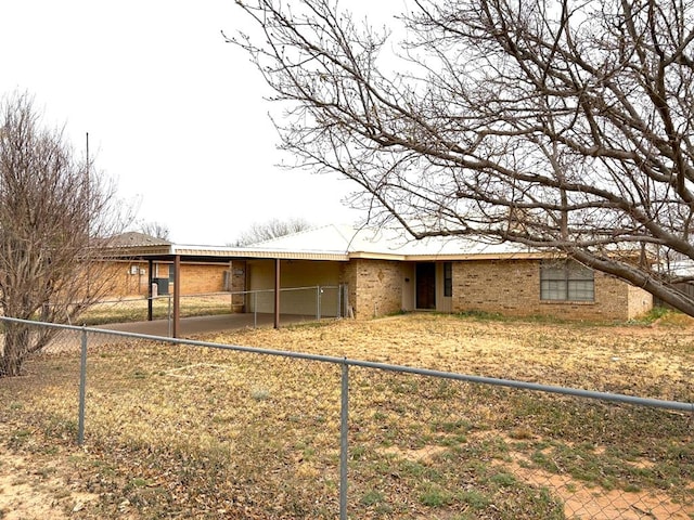 view of front of home with a carport and fence