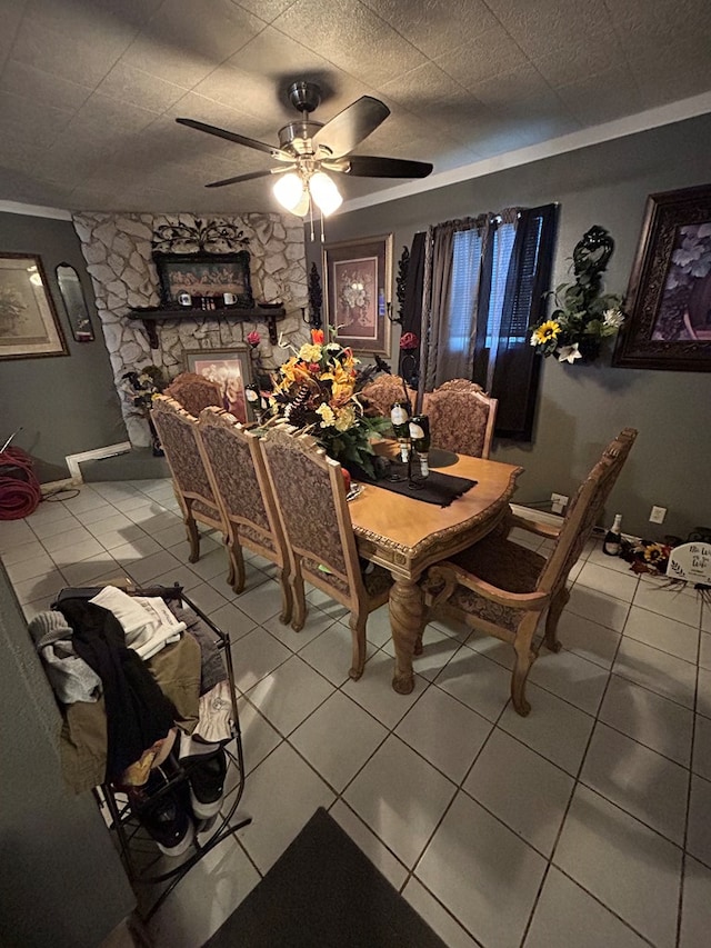 1202 N Gillis Ft, Stockton, TX 79735 - dining room featuring light tile patterned flooring, ceiling fan, and a fireplace