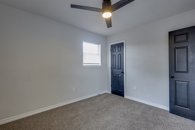 empty room featuring carpet, a ceiling fan, and baseboards