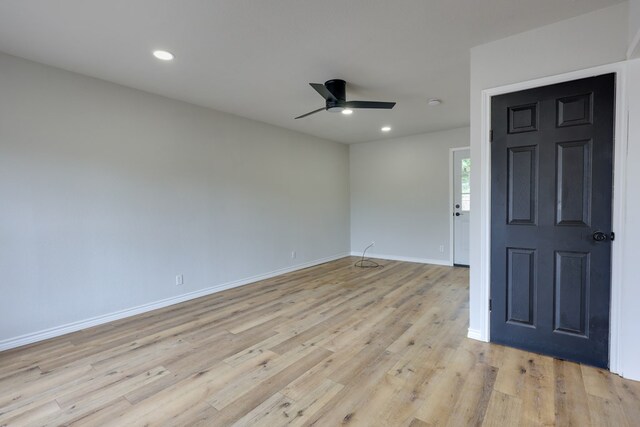 spare room featuring a ceiling fan, light wood finished floors, baseboards, and recessed lighting