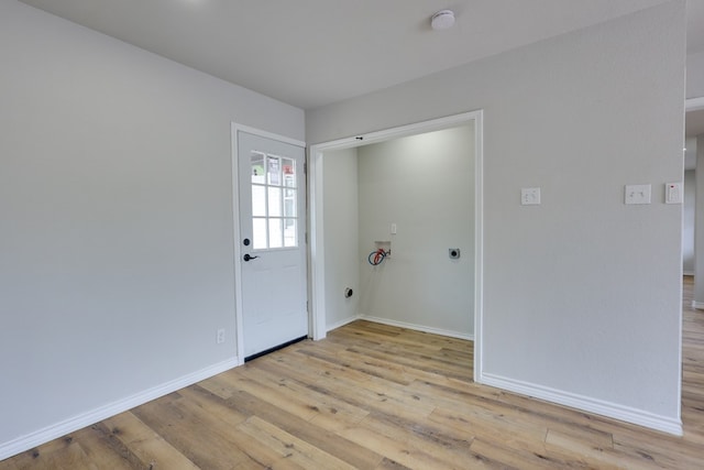 foyer entrance with light wood-type flooring and baseboards