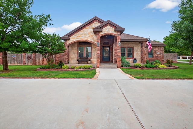 6407 Saddle Horn Ln, Midland, TX 79707 - french country style house with stone siding and a porch