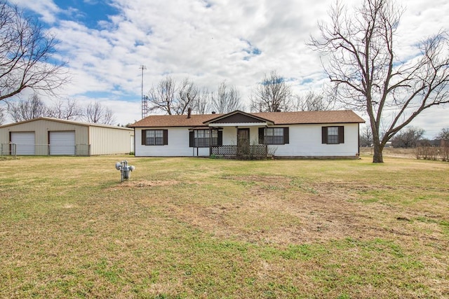 ranch-style home with a front lawn, a garage, and an outdoor structure