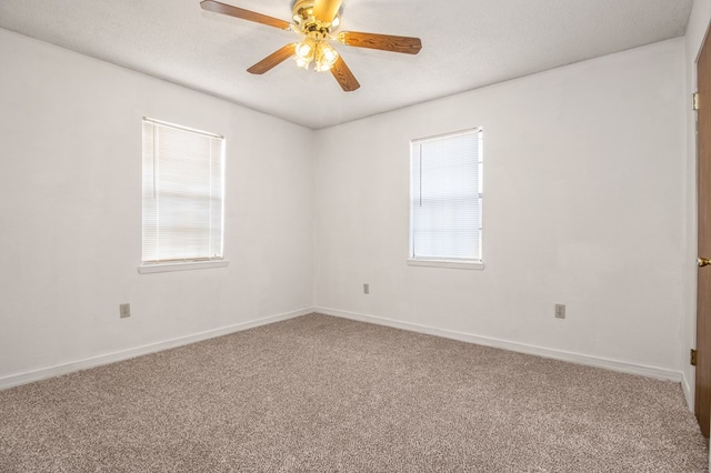 unfurnished room featuring ceiling fan, carpet floors, and a textured ceiling