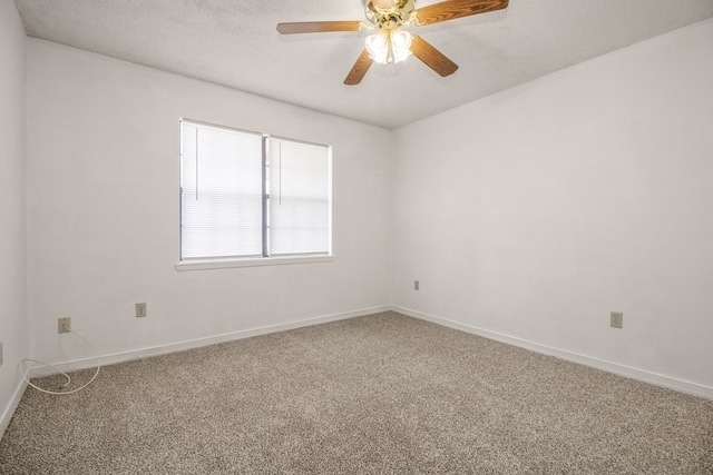 spare room featuring a textured ceiling, carpet flooring, and ceiling fan