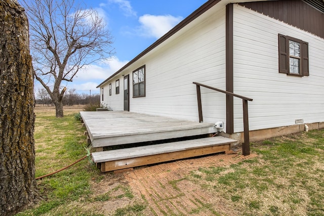 wooden deck featuring a lawn