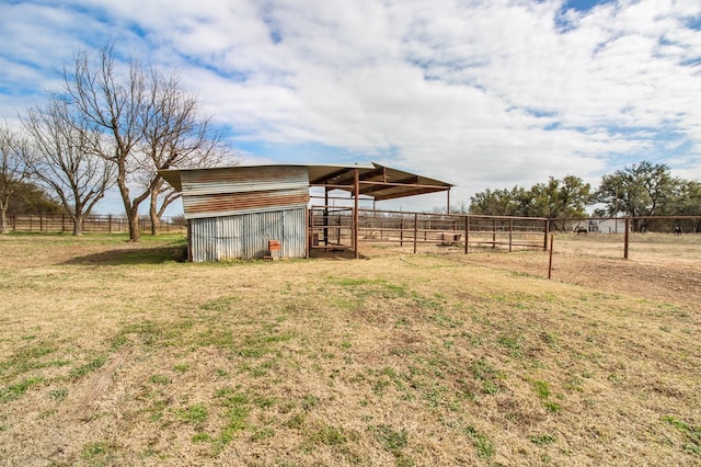 view of yard with a rural view and an outbuilding