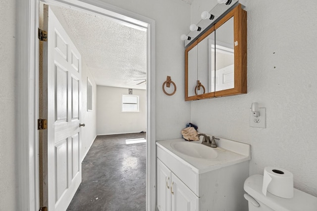 5408 E Loop 250e Unit A, Midland, TX 79705 - bathroom with concrete flooring, vanity, and a textured ceiling