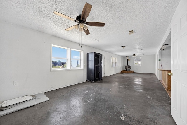 5408 E Loop 250e Unit A, Midland, TX 79705 - unfurnished living room featuring a ceiling fan, concrete flooring, and a textured ceiling