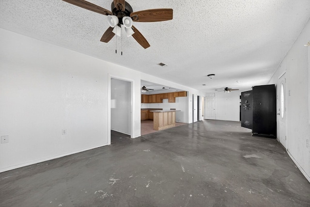 5408 E Loop 250e Unit A, Midland, TX 79705 - unfurnished living room featuring a ceiling fan, concrete floors, and a textured ceiling
