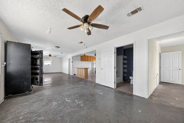 5408 E Loop 250e Unit A, Midland, TX 79705 - unfurnished living room featuring concrete flooring, ceiling fan, and a textured ceiling