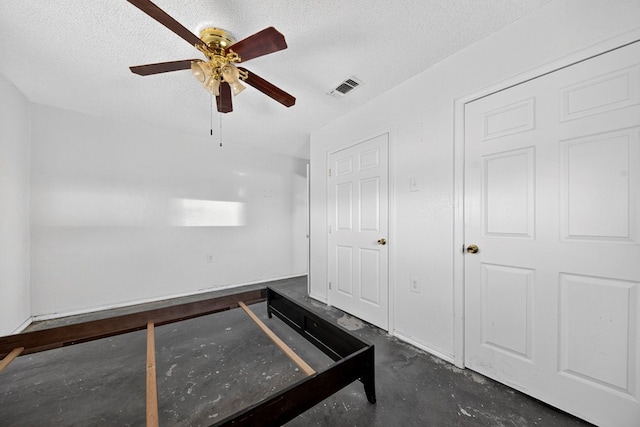 5408 E Loop 250e Unit A, Midland, TX 79705 - unfurnished bedroom featuring a textured ceiling, ceiling fan, and concrete floors