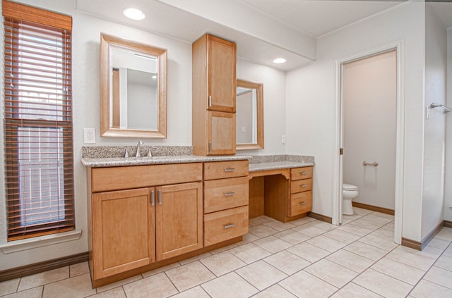 bathroom featuring vanity, baseboards, toilet, and tile patterned flooring