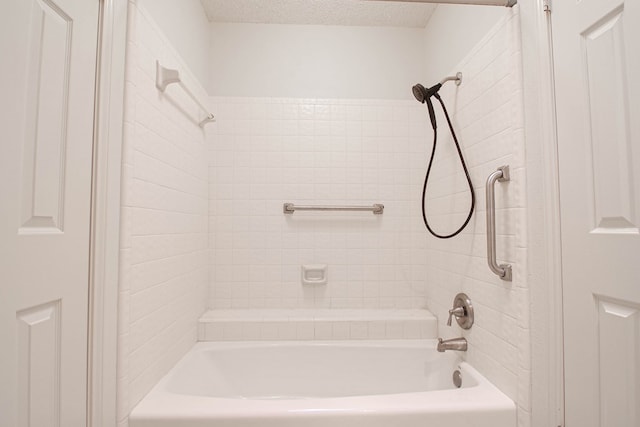 bathroom with  shower combination and a textured ceiling