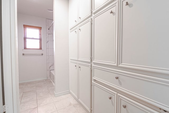 spacious closet with light tile patterned flooring