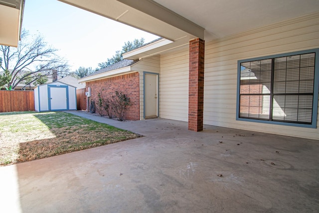 view of patio featuring fence, an outdoor structure, and a storage unit