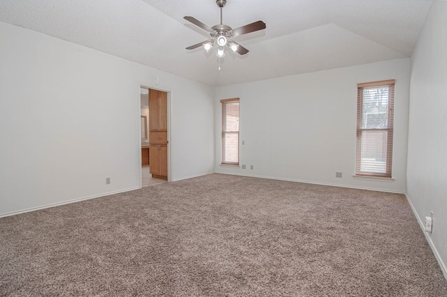 empty room with baseboards, ceiling fan, and light colored carpet