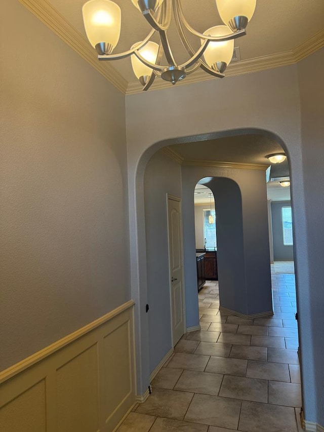 5702 San Miguel Ave, Midland, TX 79705 - hall featuring arched walkways, ornamental molding, a chandelier, and light tile patterned floors