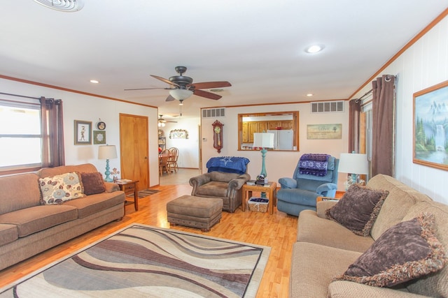 living room with ceiling fan, ornamental molding, and light hardwood / wood-style flooring