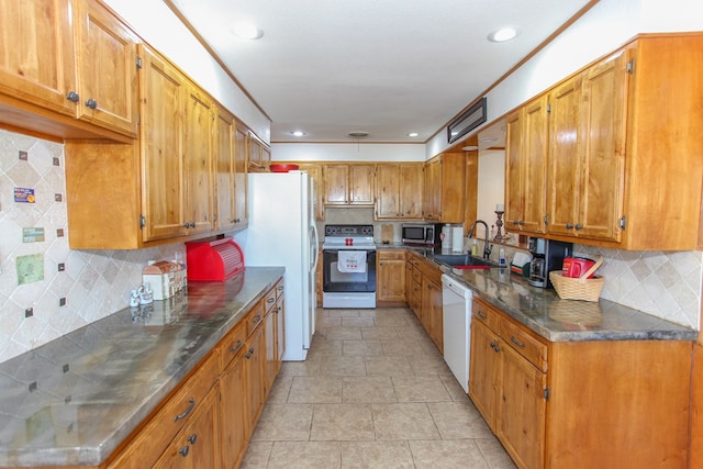 kitchen featuring tasteful backsplash, sink, and white appliances