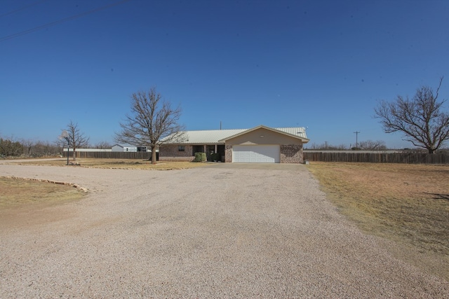 ranch-style house featuring a garage