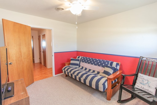 living area featuring ceiling fan and carpet flooring