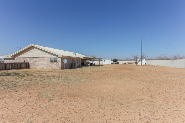 view of yard featuring cooling unit and a carport