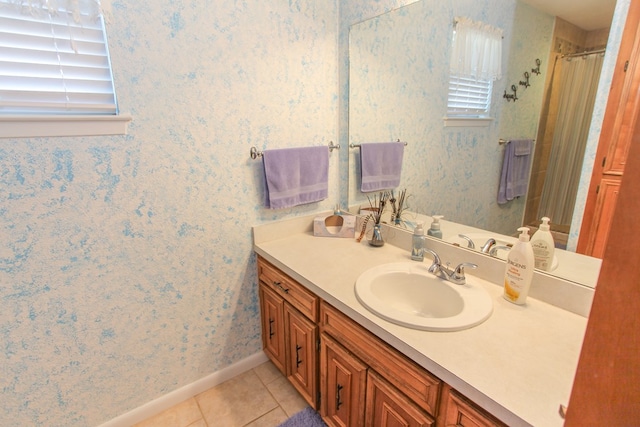 bathroom with a shower with curtain, vanity, and tile patterned flooring