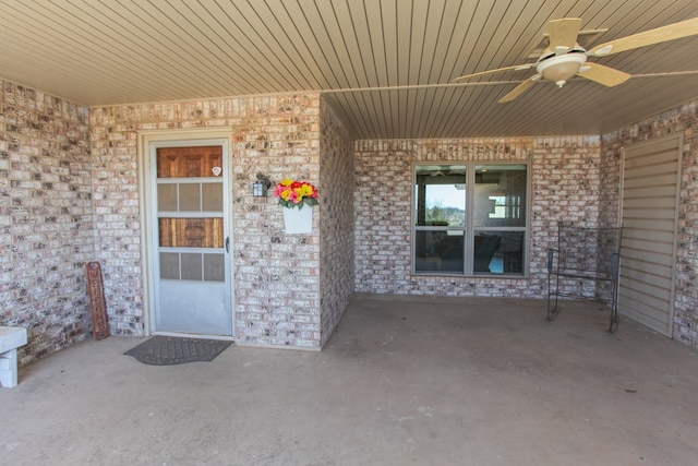 view of exterior entry featuring a patio and ceiling fan