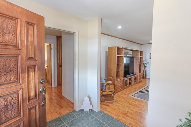 hall with dark hardwood / wood-style flooring and crown molding