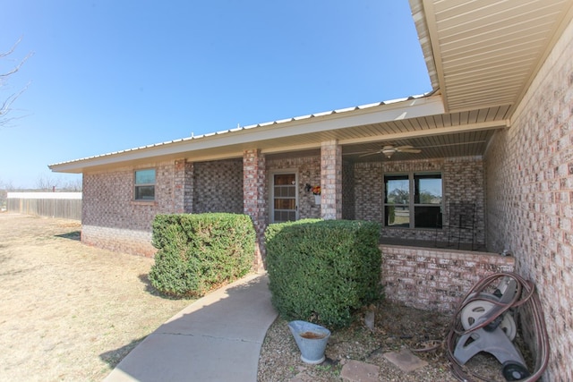 doorway to property with ceiling fan