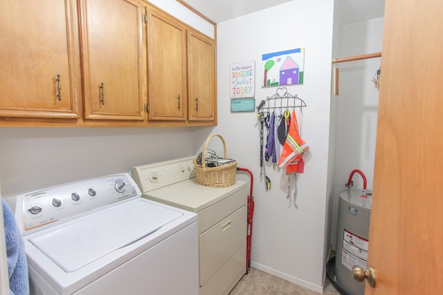 laundry room with cabinets, independent washer and dryer, and electric water heater