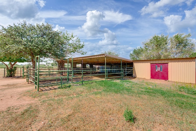 view of stable with a rural view