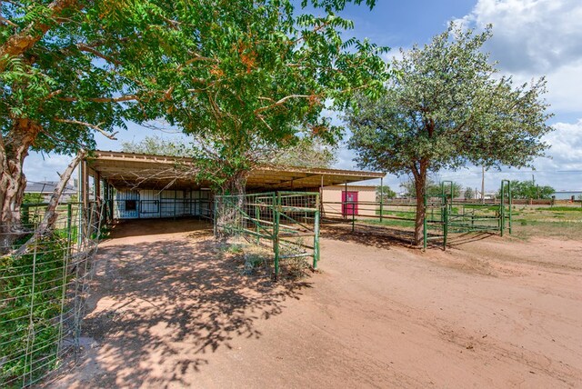 view of outdoor structure featuring an exterior structure, an outbuilding, and a detached carport