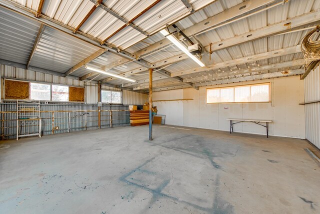 garage with a garage door opener and metal wall