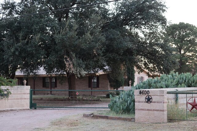 view of front of home with fence and brick siding