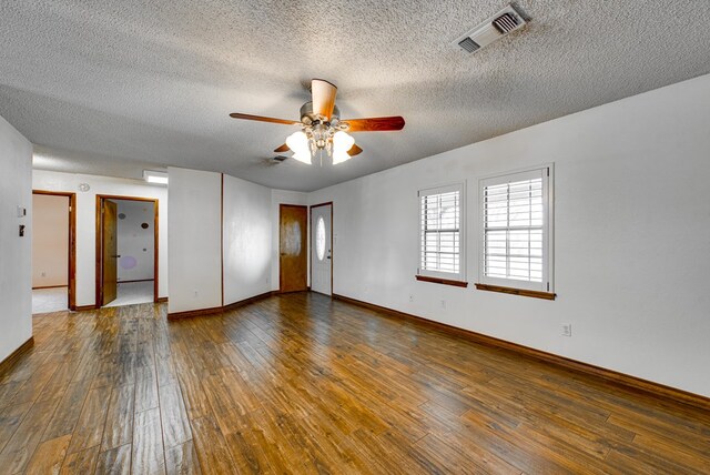 empty room featuring visible vents, a textured ceiling, ceiling fan, and hardwood / wood-style flooring